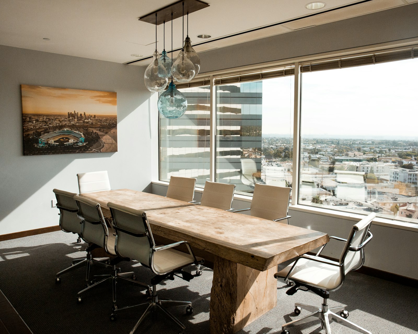 Empty boardroom with a wooden table in natural window light